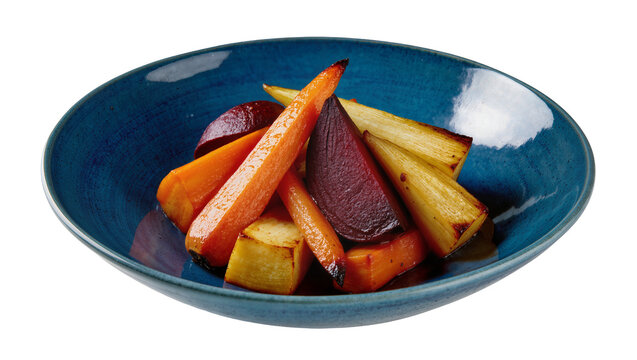 Isolated delicious roasted root vegetables with sweet carrots, beets, and parsnips in a bowl