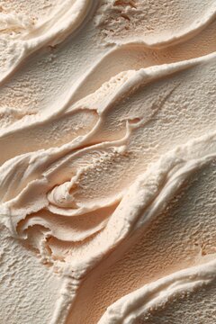 Creamy vanilla ice cream swirls in bowl. Close-up texture of soft frozen dessert. Indulgent summer treat and sweet refreshment concept for food imagery. vertical format