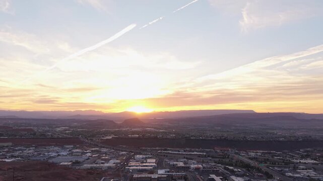 Aerial sunrise over St George city with mountain silhouette in Utah