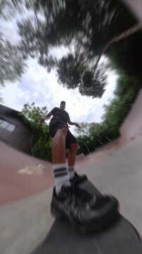 Skateboarder pov riding a half pipe ramp
