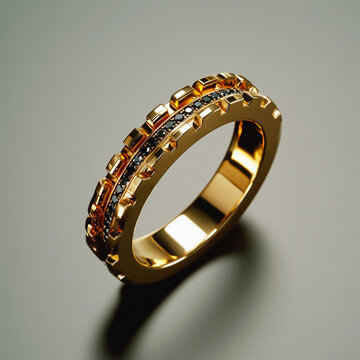 Gold ring with black stones on light background