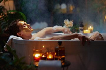 Woman with Gold Mask Enjoying a Luxury Bubble Bath © Alliance