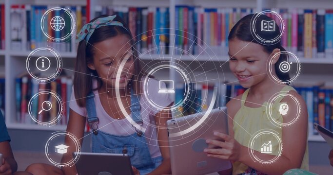 Holding tablets, two student girls in overalls and yellow dress learning at library bookshelf, HUD