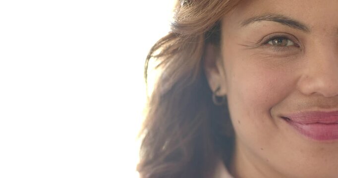 African American woman smiling then laughing while turning head in right closeup, hoop earring