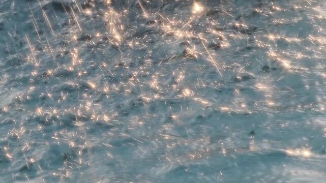 Bokeh effect blurring starbursts, light reflections, and water splashes from a fountain.