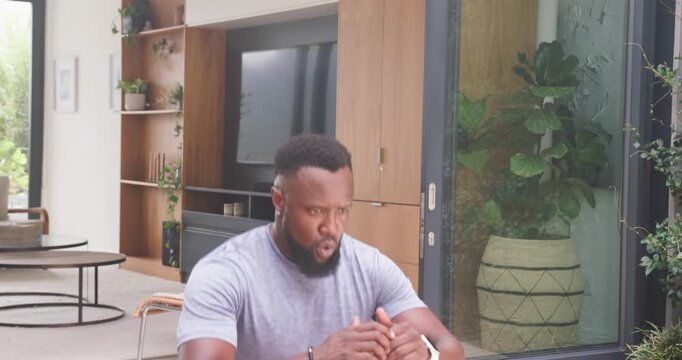 African man starting kneeling moving lunging and squatting on patio for training with weights