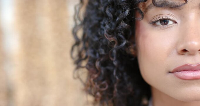 Adult African-American woman on cue opening eye smiling laughing in studio gold drape, copy space