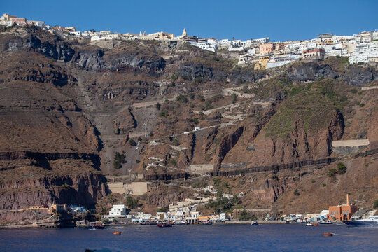 Santorini caldera cliffs with layered volcanic rock and sea view