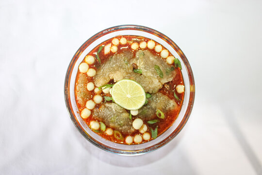 Indonesian Spicy Baso Aci Soup With Lime And Chili In Glass Bowl