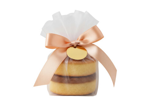 Traditional Brazilian bem casado cake in peach ribbon packaging