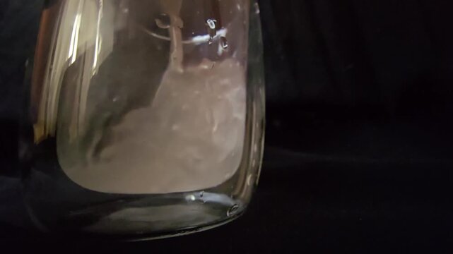 Macro shot of frankincense resin, also known as luban or olibanum, dissolving in a glass of water for traditional medicine and skincare concepts.