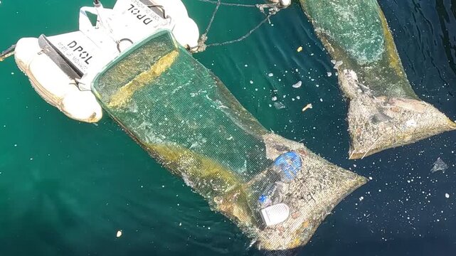 Top Down View of Floating Waste Collectors Trapping Debris in Water