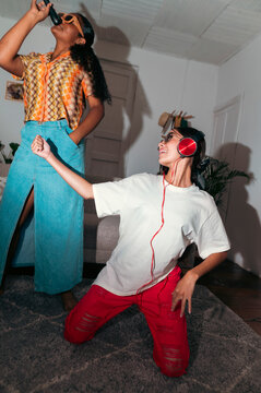 Friends enjoying music and singing at home