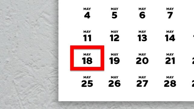 The date May 18th marked with a red cursor on the wall calendar 2026