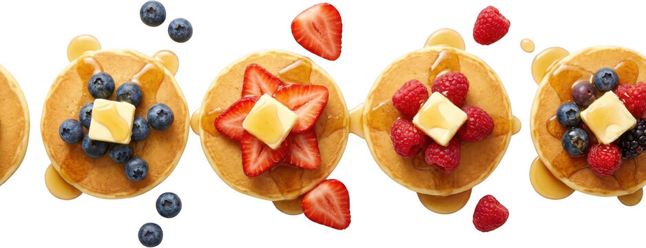 Delicious stacked pancakes topped with fresh blueberries sliced strawberries raspberries butter and syrup in a row breakfast berry fruit food sweet dessert blueberry strawberry