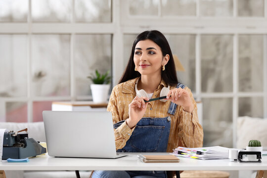 Female screenwriter working at table in office