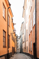 Fototapeta premium Gamla Stan old city in Stockholm, Sweden. Historic yellow and orange homes with narrow alleys.
