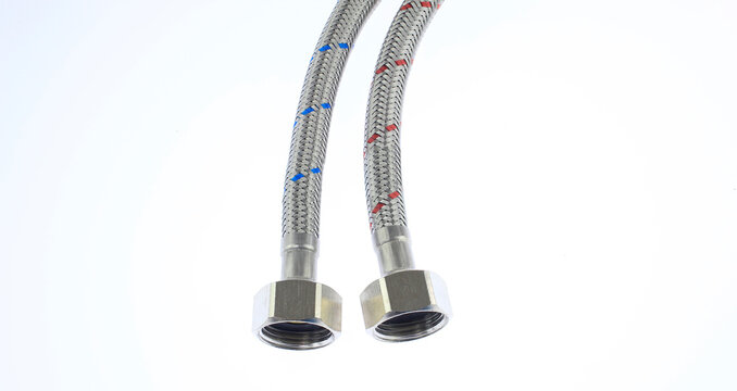 Metallic flexible hose with braided texture and threaded ends. White background emphasizes product details clearly.  plumbing hoses featuring, female threaded connectors isolated on white background. 
