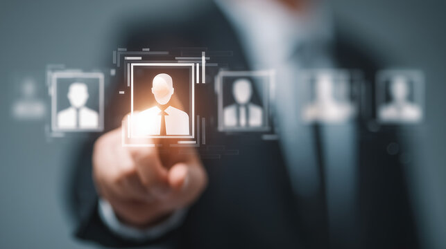 A businessman selects a candidate from a digital interface displaying multiple employee profile icons.