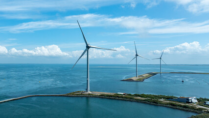 Wind Turbines in Coastal Waters of the Netherlands Generating Renewable Energy Under Blue Sky With Clouds © Vit Onopriienko