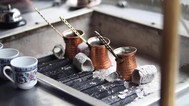 Making traditional turkish coffee in a Turkish kitchen by fire