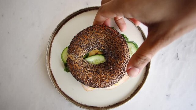 Making a simple bagel sandwich with fresh ingredients
