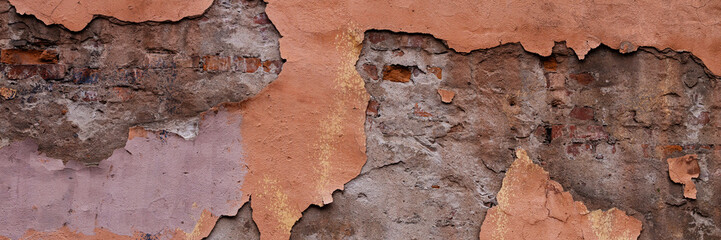 Fototapeta premium Old wall with cracked plaster. Weathered rough surface. Wide panoramic texture for background and design.
