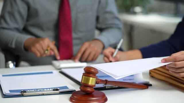 Teamwork of business lawyer meeting working hard about legal legislation in courtroom to help their customer