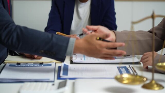 Lawyers and business professionals discuss contract papers at the office. legal and corporate consultation concept focusing on law, advice, and business agreements.