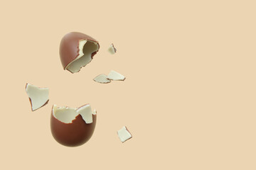Naklejka premium Broken chocolate egg flying on beige background