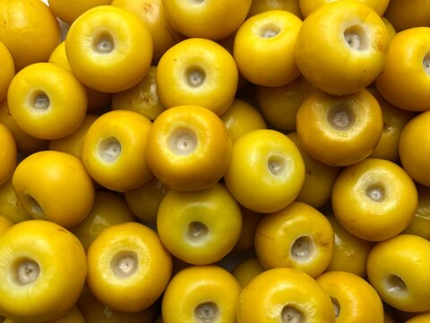 Close-Up Pattern of Ripe Yellow Nanche Fruits (Nance) with Visible Peduncles