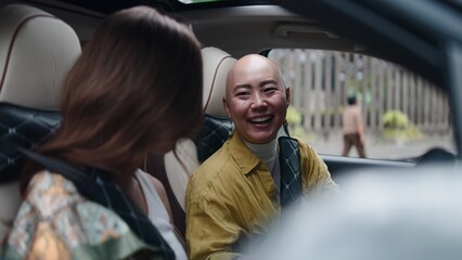 Fototapeta premium Thai women friends laughing in car, enjoying trip, road safety