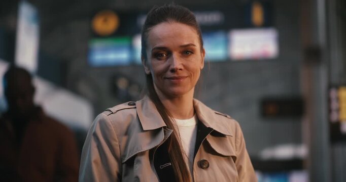 Stylish and Professional Young Woman Stands Confidently in Airport Departure Hall. Positive Emotions of Travel, Holiday Anticipation, and Carefree Lifestyle of Modern Independent Woman. Portrait.