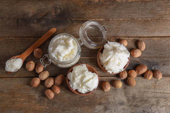 Composition with shea butter and nuts on wooden background