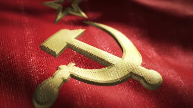 A textured, red flag with gold hammer, sickle, and star