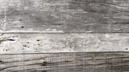 Weathered grey wood plank background with distressed texture and visible grain, creating a rustic vintage surface perfect for natural design, abstract backdrops, and aged material visuals. © Entas