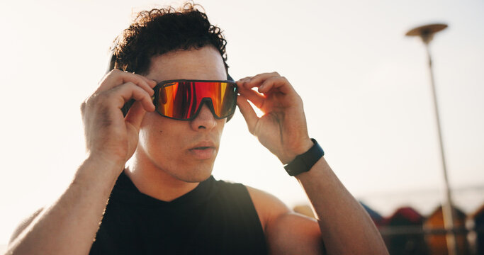 Fitness, outdoor and man with wellness, glasses for uv protection and thinking. Person, exercise and athlete with eyewear for vision, workout and polarized lenses for sight, reflection and fashion