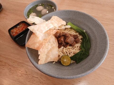 Mie Ayam or Chicken Noodle, Indonesian Popular Street Food with Noodle, Chicken, and Vegeta bles in a bowl. 
