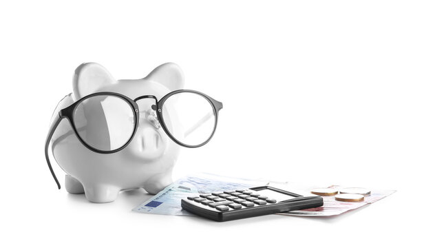 Piggy bank with money and calculator isolated on white background