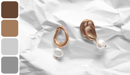 Beautiful earrings on crumpled paper background