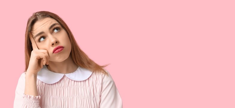 Thoughtful young woman trying to remember something on pink background with space for text