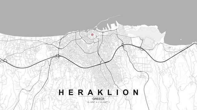 Monochrome city map of Heraklion, Greece with a red location marker highlighting a point, showing streets, coastline, and dense urban road network layout
