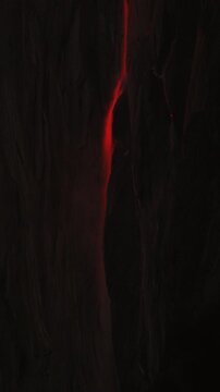 Vertical Screen: Yosemite National Park Firefall phenomenon with glowing red-orange light streaming down dark granite cliff face creating dramatic natural spectacle at dusk