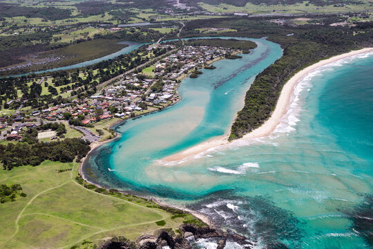 Aerial view of the stunning turquoise blue ocean water adjacent the picturesque Minnamurra township, just south of Shellharbour and Killalea Beach on the Illawarra South Coast of New South Wales.