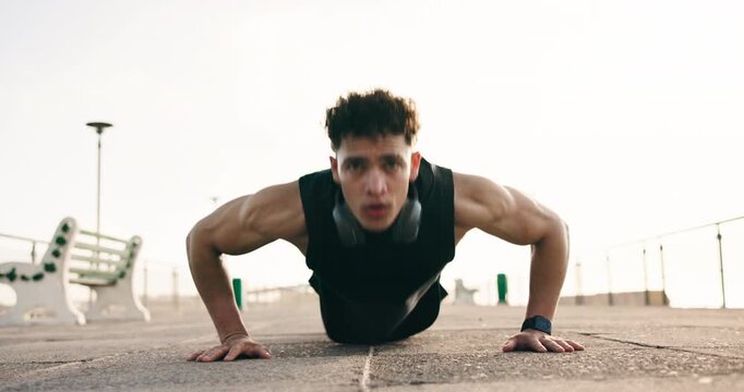 Fitness, push up and man in city for training, cardio workout and core exercise on ground. Athlete, portrait and person with routine for muscles, strength and active hobby for wellness and health