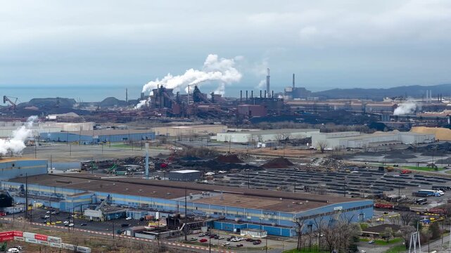 Aerial view of Industrial steel plant pollution emitting smoke