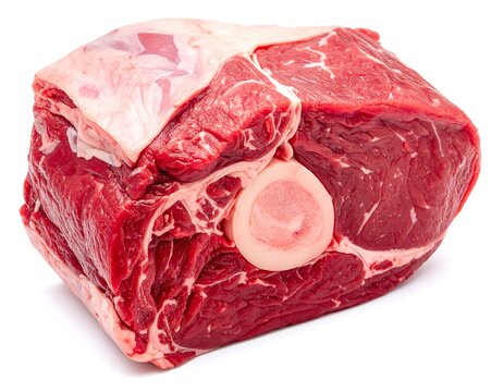 Large raw meat cut, showing muscle fibers, bone marrow. Freshly butchered, detailed texture on a white backdrop