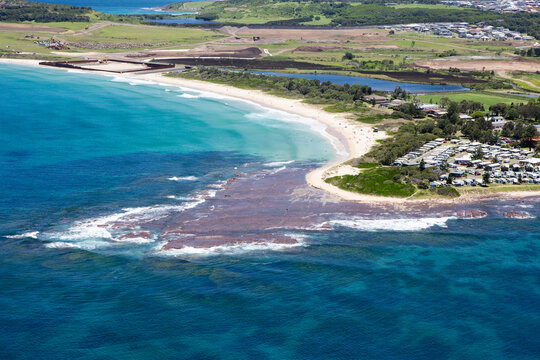 Historic view of Shellharbour South Beach prior to the construction of Shell Cove and Marina, located south of Wollongong on the Illawarra coastline. Captured from high above on a blue sky day. 