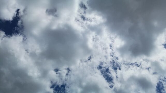 Camera pans left across layered clouds against a blue sky