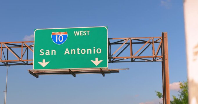 A crisp aerial drone shot of the iconic I-10 West San Antonio directional freeway sign in downtown Houston, Texas.